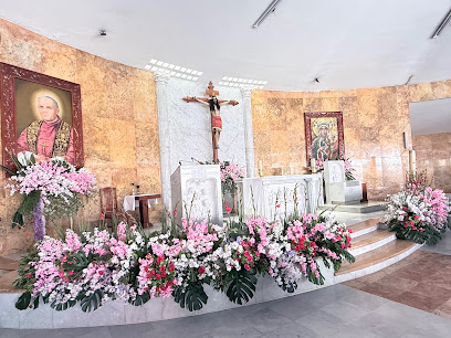 Altar del Templo Nuestra Señora de Czestochowa y San Juan Pablo II decorado con flores rosas y blancas